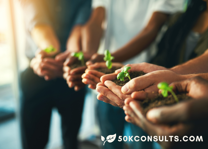 scaling means more in business, people lined up with plants and soil in their hands indicating team work. Ivory leaf and 50kconsults.com logo appears in bottom right corner. Heather Deveaux.